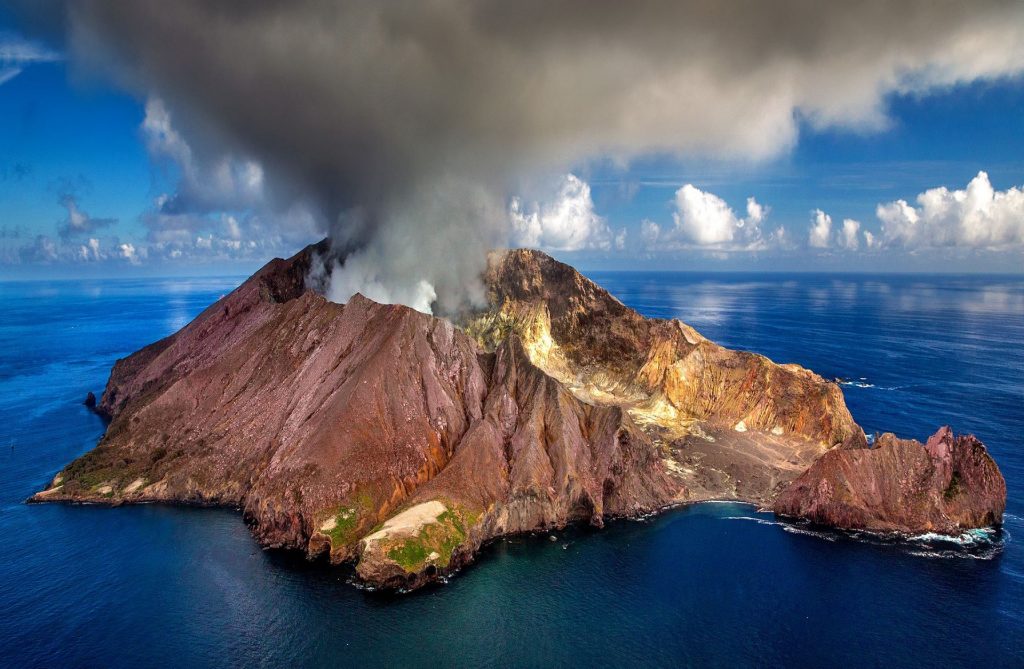 smoking volcano in ocean
